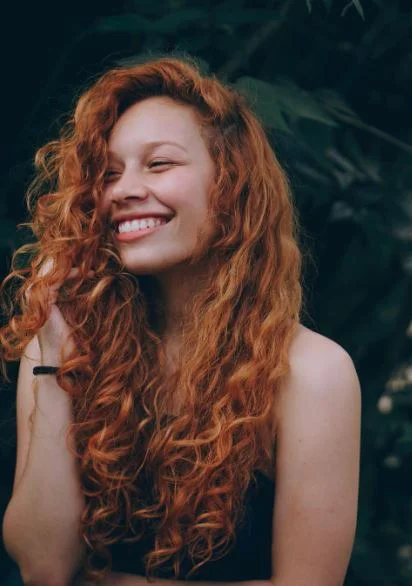 Dentist Mill Creek WA Porcelain Veneers An attractive young woman with bright white teeth smiling broadly